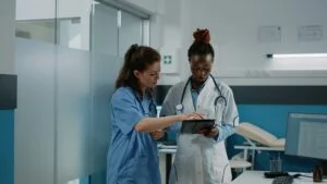 Nursing Careers 2 Business Services and Staffing Solutions - Nursing, Mine Services, Remote Digital Confined Space Monitoring, Alberta trucking, alberta transportation services, oil and gas Doctor and nurse working with tablet for healthcare system