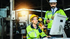 inspector look on screen monitor on desk to control industry