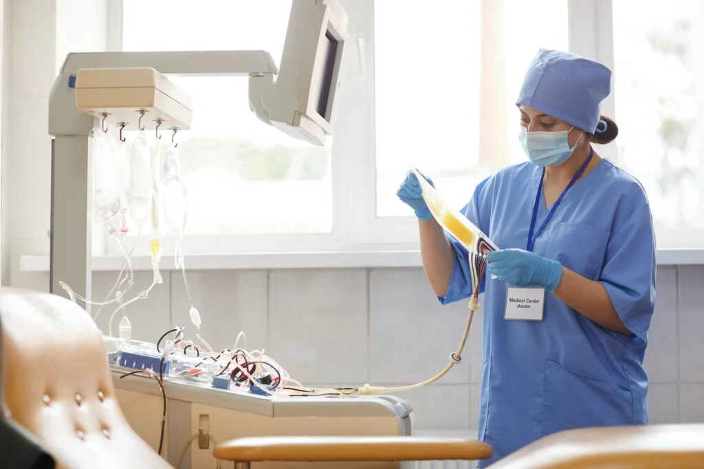 Nursing Careers 1 Business Services and Staffing Solutions - Nursing, Mine Services, Remote Digital Confined Space Monitoring, Alberta trucking, alberta transportation services, oil and gas Nurse working with dropper